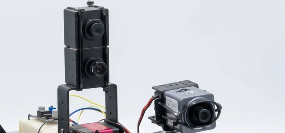 Two cameras on a driven rotating stage beside a fixed telephoto camera